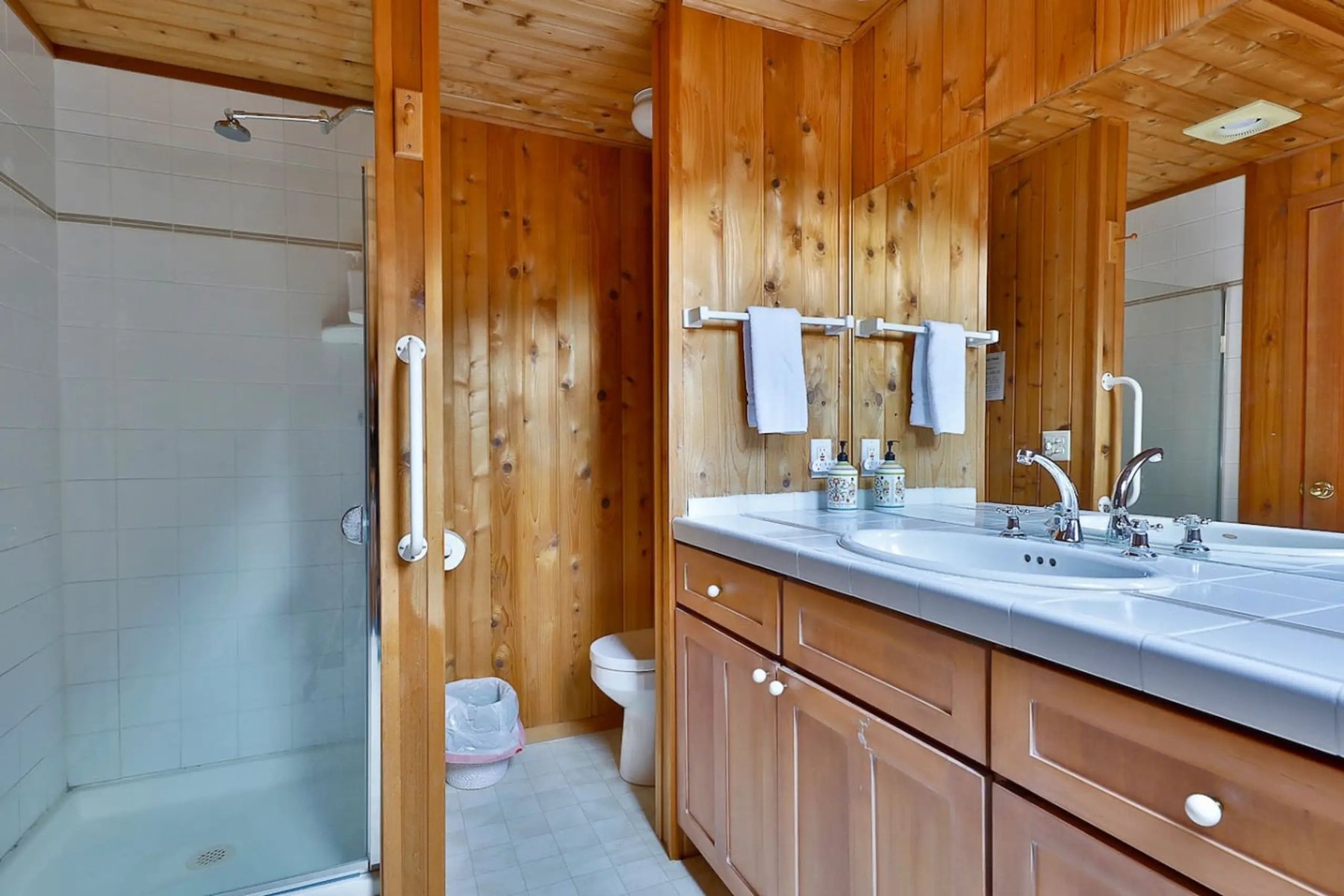Main bathroom with tiled shower and double vanity