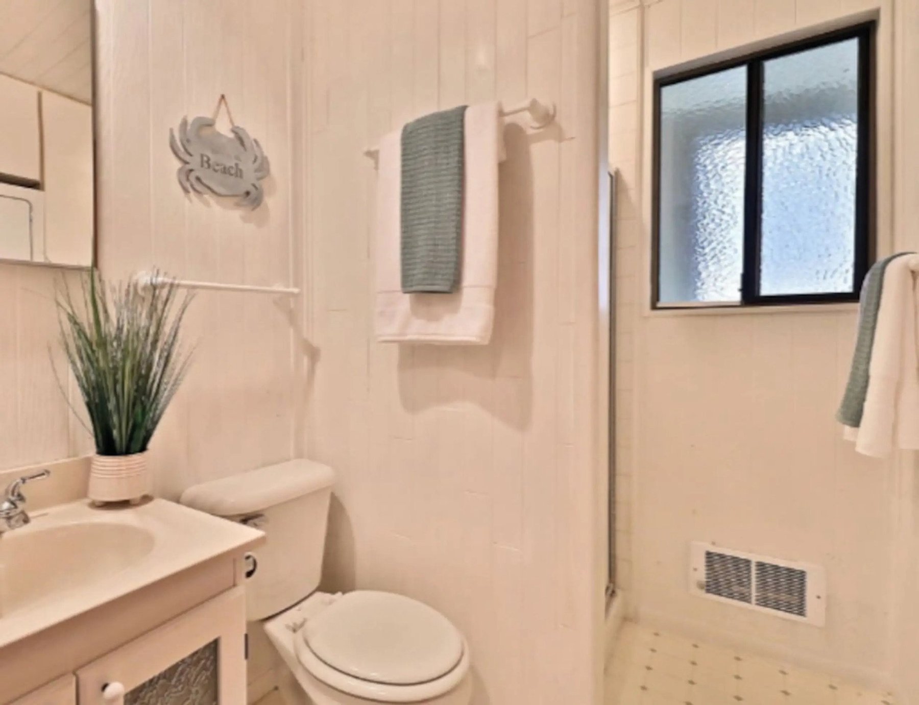 Bright white bathroom with beach-themed decor